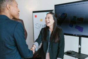 woman in black blazer smiling